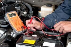 a person works on car battery services