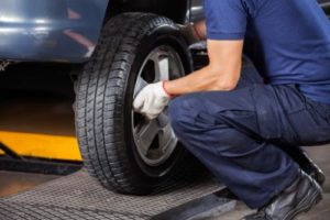 a mechanic works on auto tire and wheel services